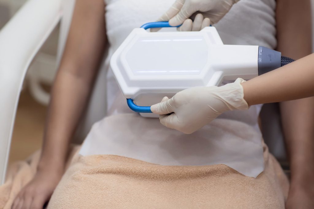 A woman undergoing fat freezing treatment at a medispa.