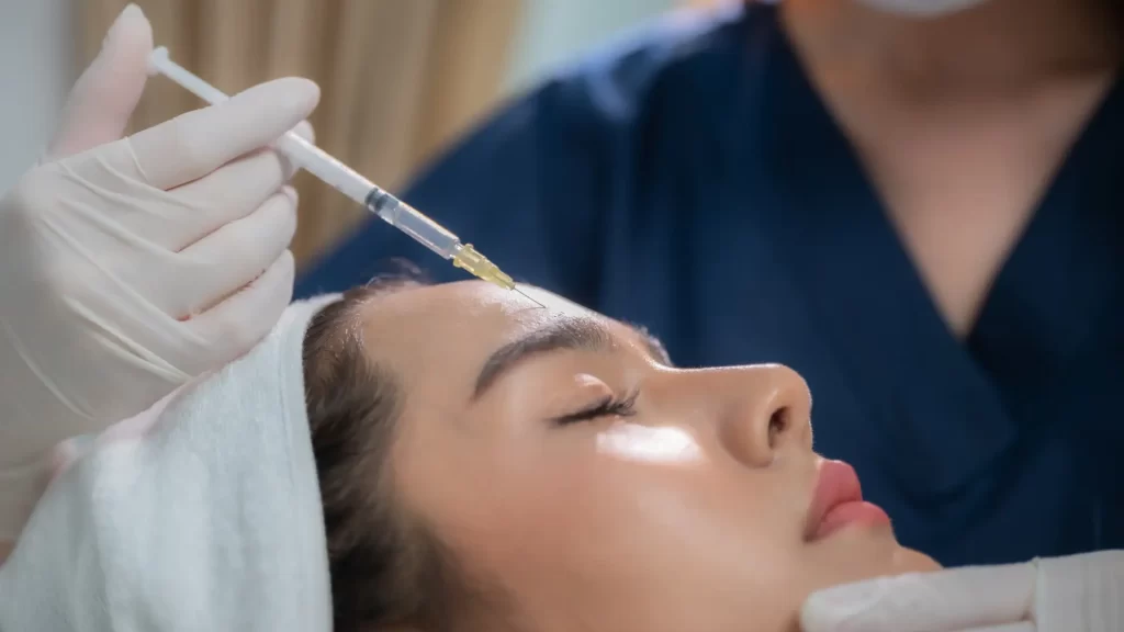 Woman receiving injectable collagen booster treatment.